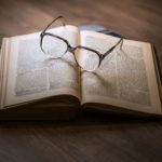 About Us Flash Fiction Online Glasses on an opened book