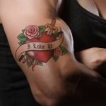 muscular arm with heart tattoo